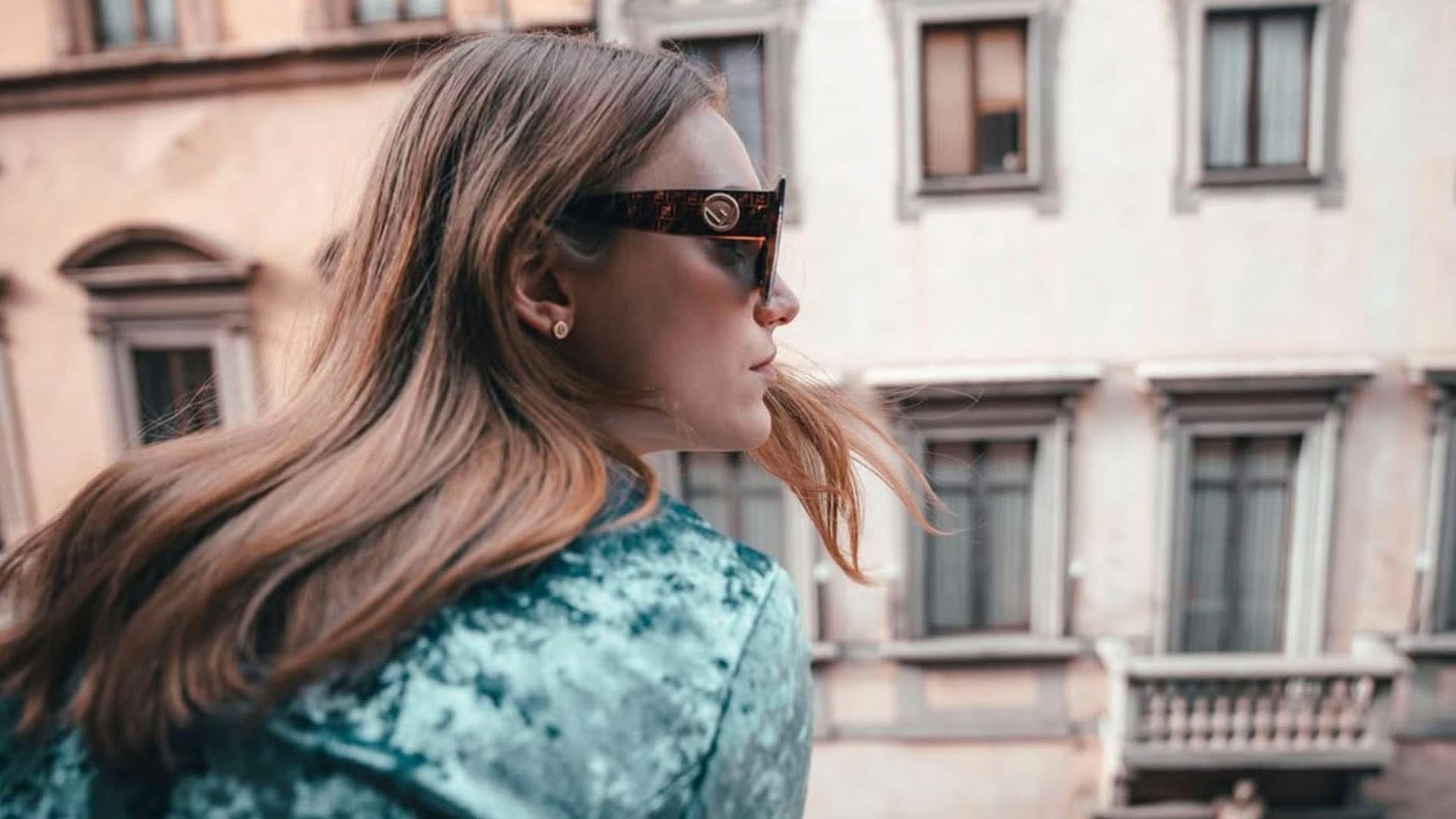 Girl wearing sunglasses looking out the window