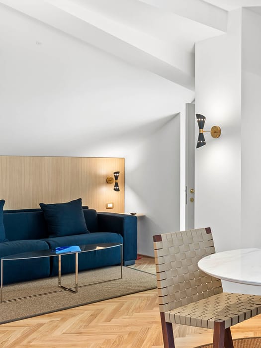 Detail of Prestige Quadruple Room with a sitting area and comfortable sofa